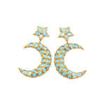 Gold and turquoise colored moon and star shaped earrings on a white background
