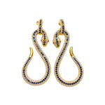 Gold snake-shaped earrings with blue and red crystals on a white background