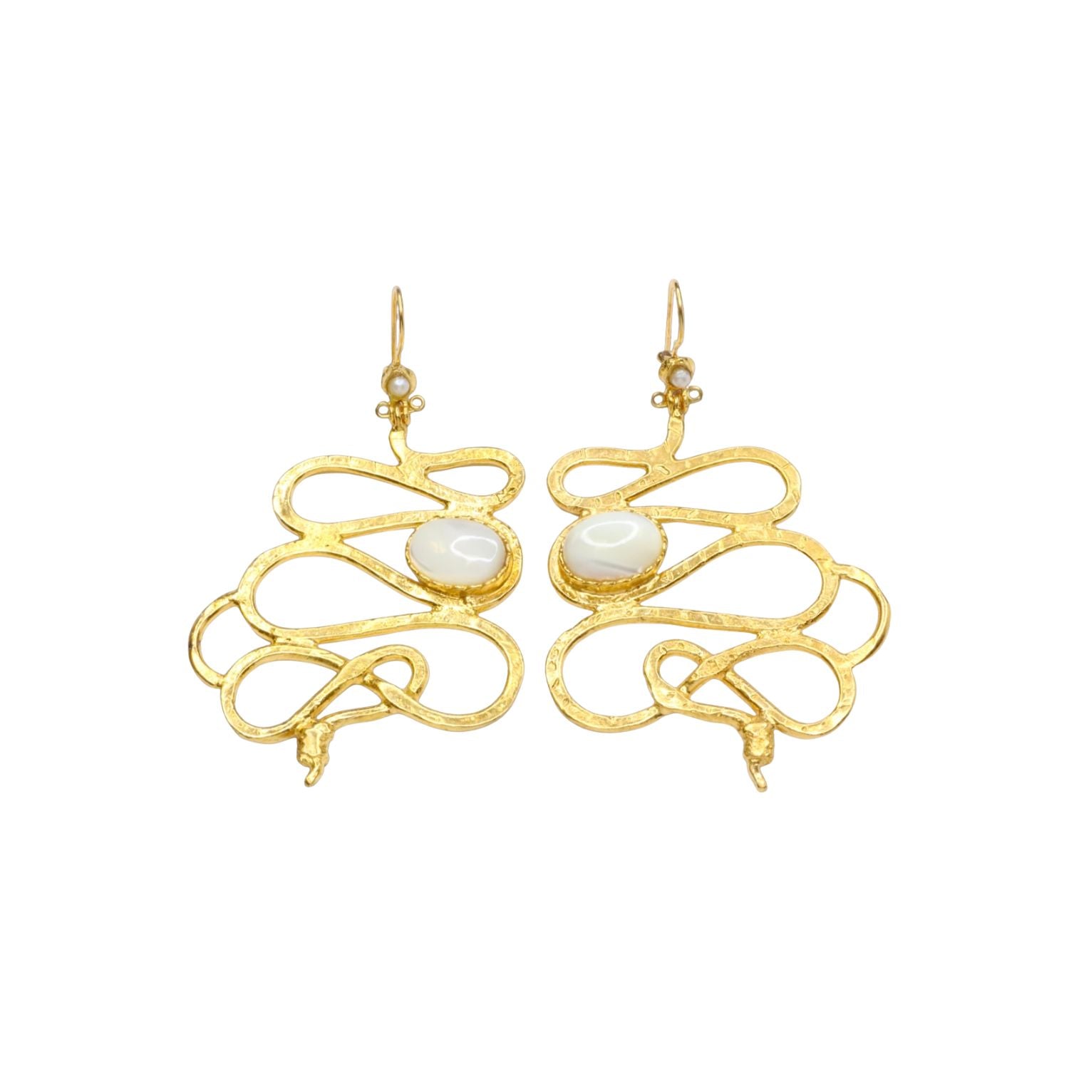 Gold colored snake shaped earrings with white stone accents on a white background