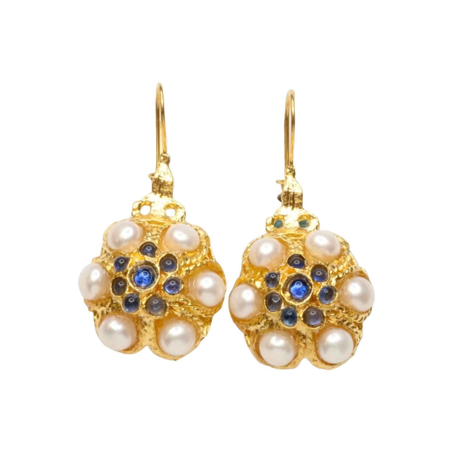 Gold flower shaped earrings with pearl like beads and blue stones on a white background