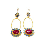 Gold colored earrings with dark magenta and blue stone accents on a white background