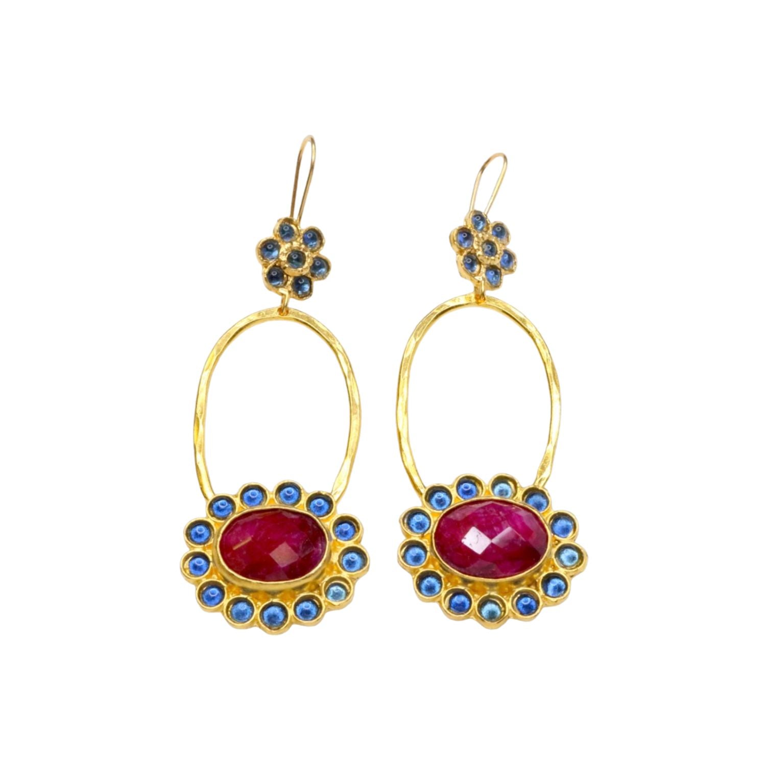 Gold colored earrings with dark magenta and blue stone accents on a white background