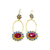 Gold colored earrings with dark magenta and blue stone accents on a white background