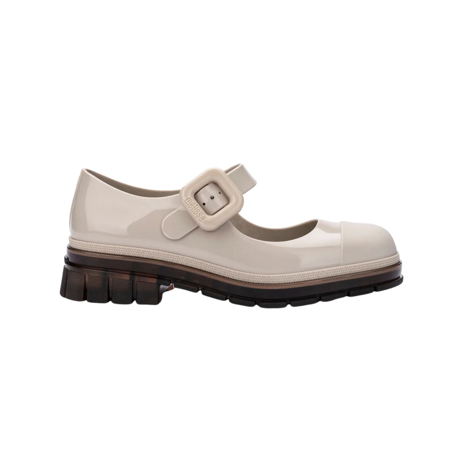 The June Mary Jane by Melissa features a neutral beige hue, slight heel, fun bubblegum scent, and large buckle detail