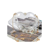 clear lip shaped purse with gold colored chair strap