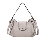 Light gray handbag with tassels and a strap 