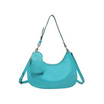 Turquoise handbag with a shoulder strap and hand strap and small accessory bag