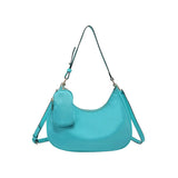 Turquoise handbag with a shoulder strap and hand strap and small accessory bag