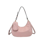 Pink handbag with a shoulder strap and hand strap and small accessory bag