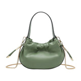 Green handbag with chain detail and hand strap