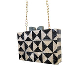 Black and white geometric patterned handbag with gold chain strap