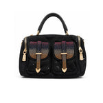 Black handbag with gold accents and decorative elements