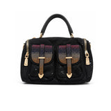 Black handbag with gold accents and decorative elements