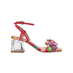 Colorful sandal with floral design, ankle strap, floral applique, and a clear heel on a white background