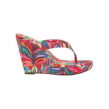 Colorful wedge sandal with a vibrant paint inspired floral pattern 