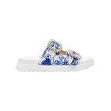 White sandal with blue bejeweled floral pattern and embellishments