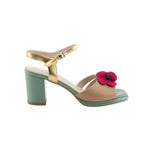 Open toe heeled shoe with gold strap, green sole, tan toe strap and raspberry flower