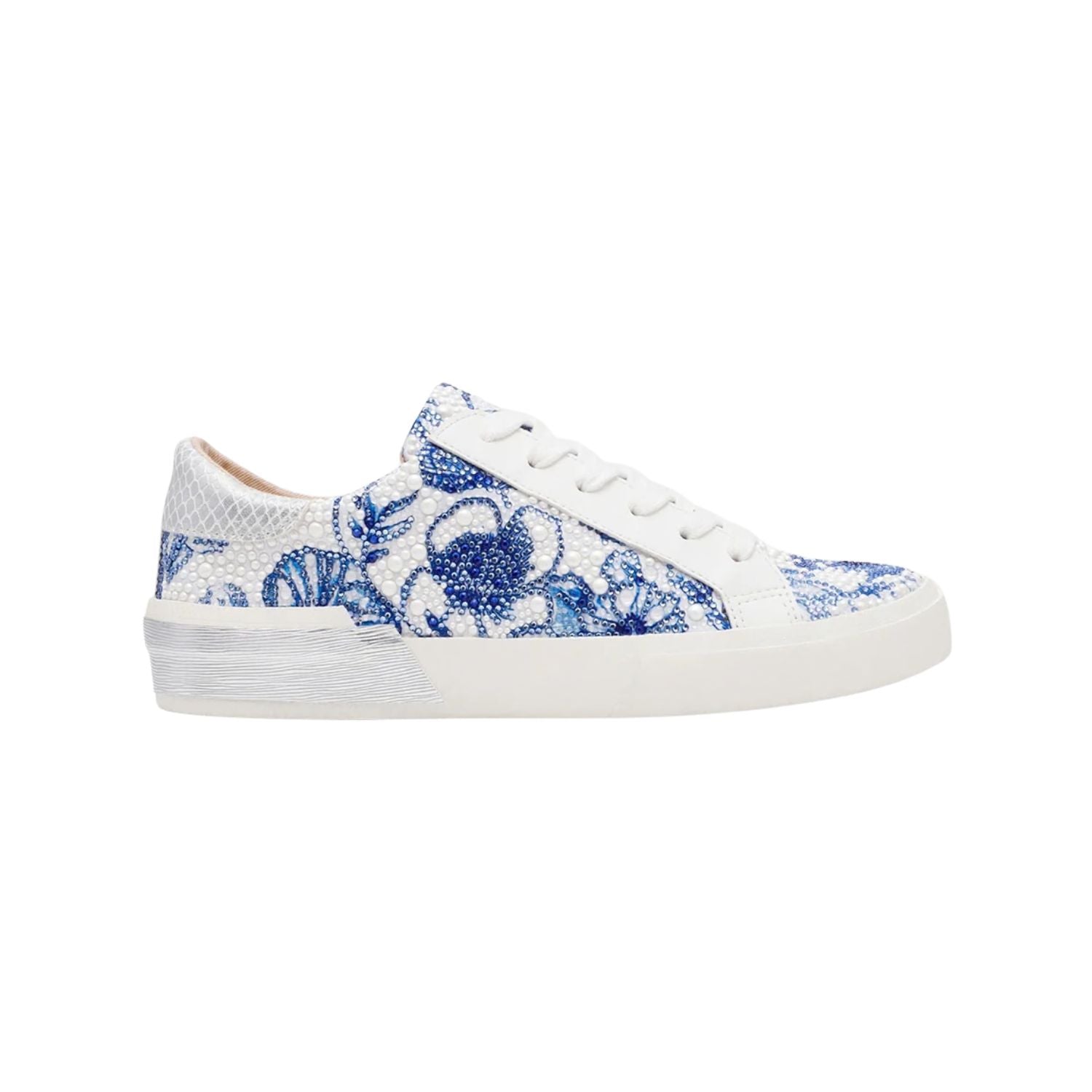 White sneaker with blue floral pattern on a white background