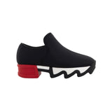 Black slip-on shoe with a red heel and black & white sole