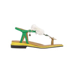 Green sandal with a white flower and yellow heel