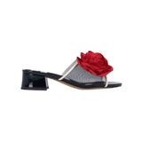 Black heel with a red flower and white/transparent strap