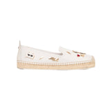 White flat moccasin-styled shoe with decorative elements 