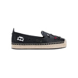 Black flat moccasin-styled shoe with decorative elements 