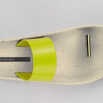 Beige sandal with yellow strap and a metallic toe catch close-up